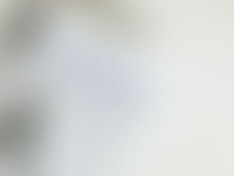 An uncapped red-tipped pen lies above a lined notepad featuring a handwritten" To Do List" with tasks like decluttering and organizing listed, all set on top of a clipboard against an off-white surface.