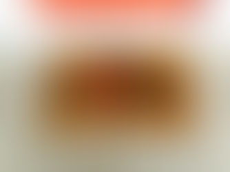 A mahogany-colored welcome doormat with "H❤️ME" text in black sits in front of a red door on a wooden porch.