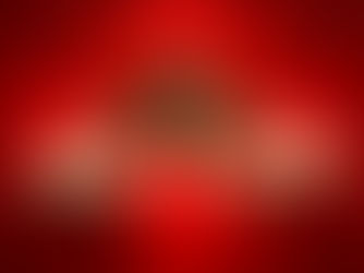 A blonde woman wearing a red dress poses with hands on her summer hat while smiling against a red background.