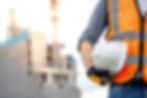 Safety workwear concept. Male hand holding white safety helmet or hard hat. Construction w