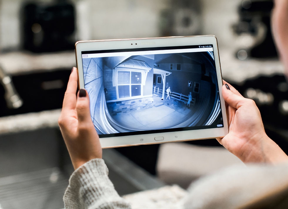 Person holding tablet showing home security camera footage, BUGGEROFF-Security