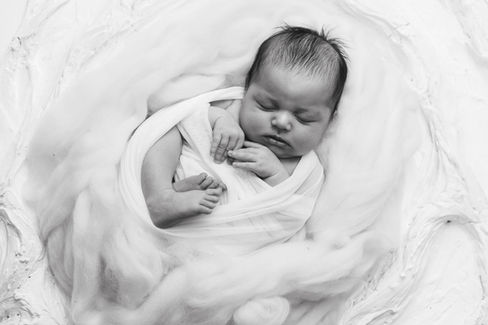 sleeping newborn baby on white blanket in Gilmer Texas photography studio