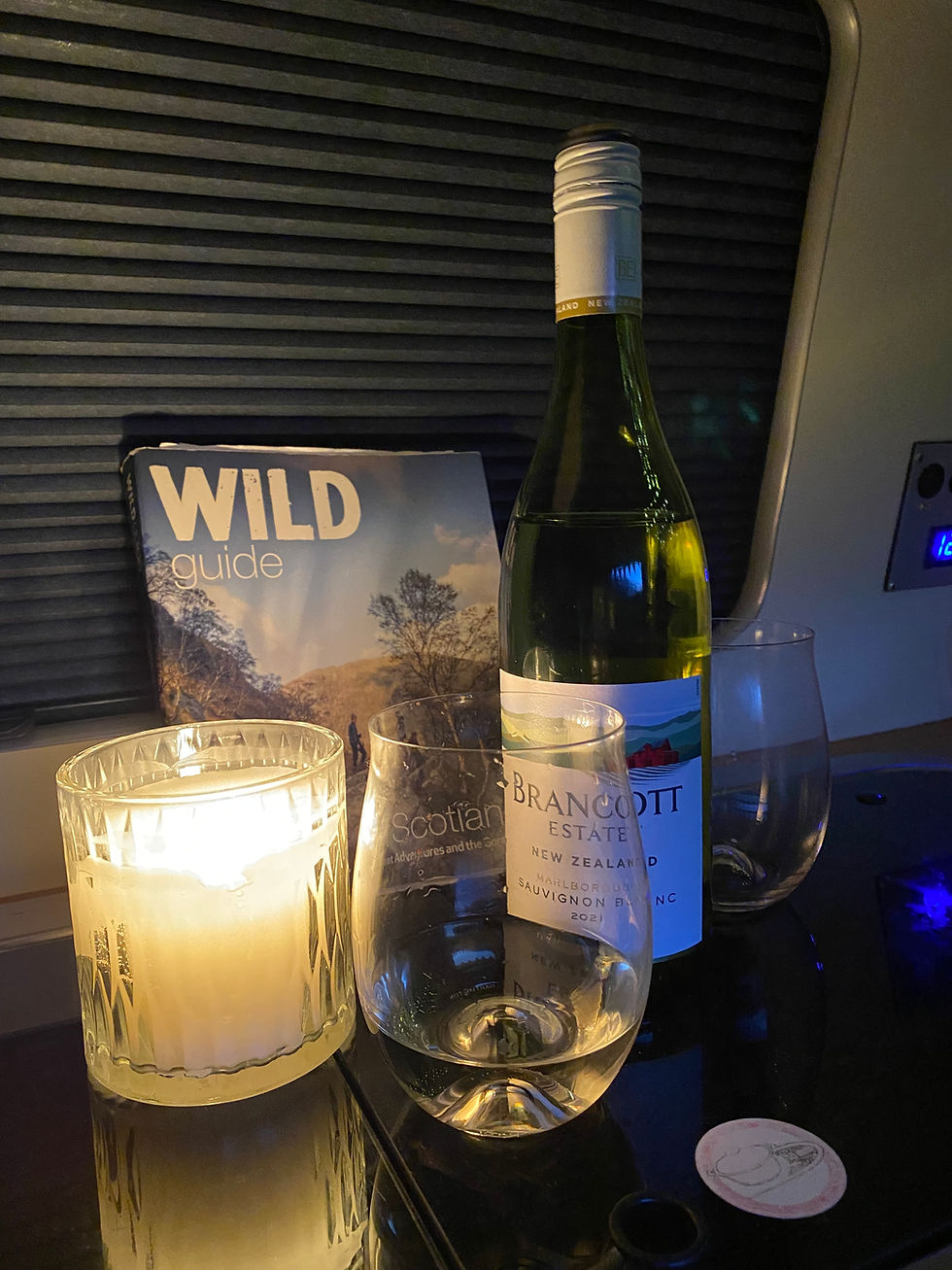 wine and candles in a vw campervan