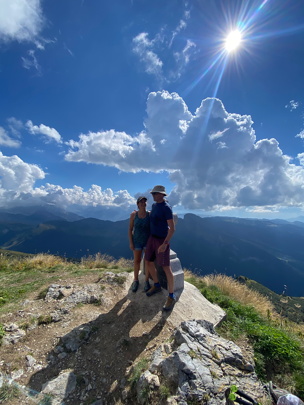 Couple at sunny summit of Pointe de Ressachaux
