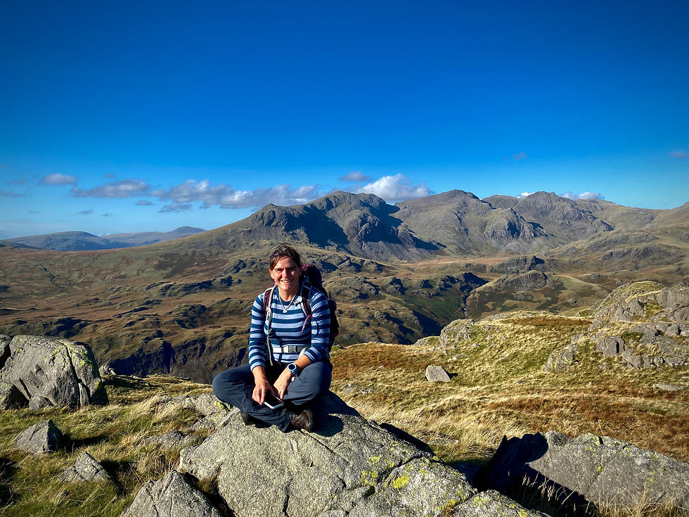 Woman hiker sat on summit of Hard Knott
