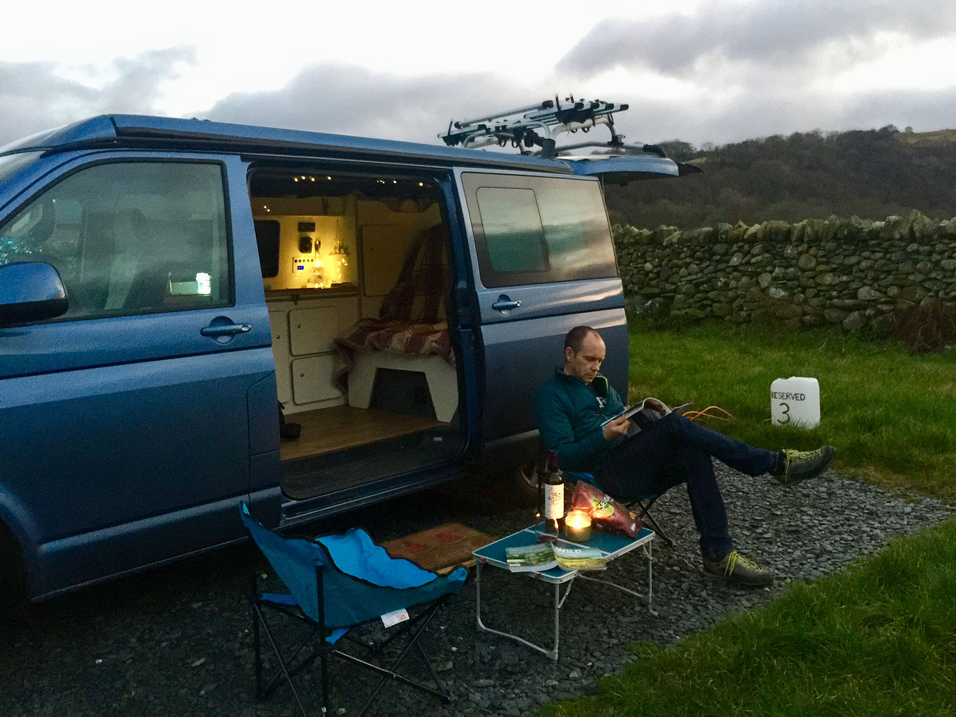man sitting infront of VW camper