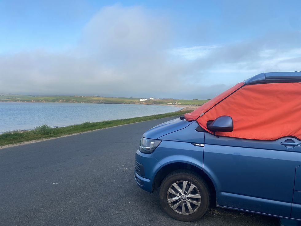 blue vw camper next to the sea