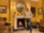 Man stood in front of grand open fire
