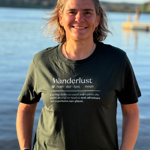 woman in an early retirement wanderlust t shirt 