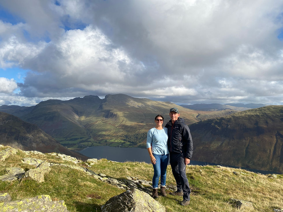 Couple on summit of Middle Fell overlooking Wasdale in the English Lake District