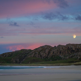 moon rising on reef beach at sunset