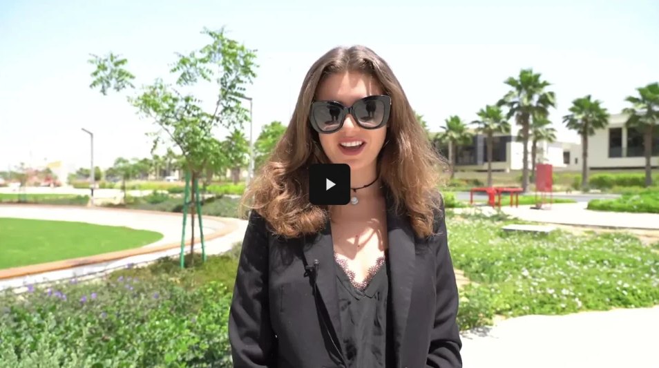 Presenter walking through a sunlit community park