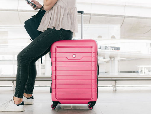 Woman sitting on suitcase