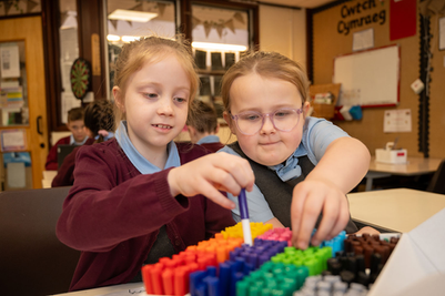 Two girls interact with colorful markers in a classroom setting, Year 4 Beaufort Hill