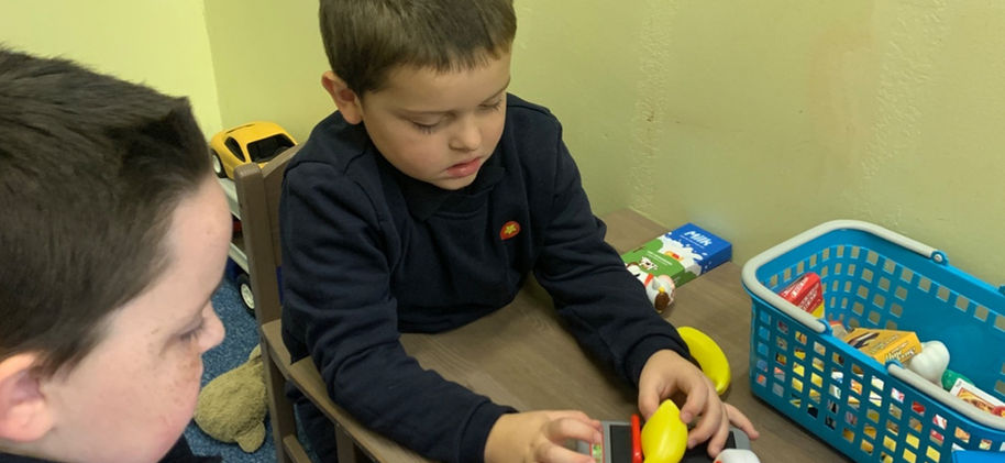 Two boys role-playing shopkeepers at Pembroke Primary School