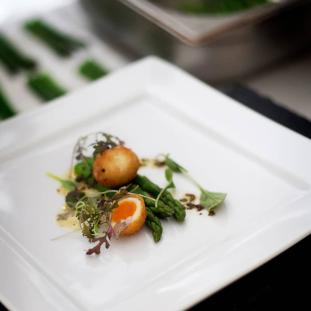 Chef Scott Whitehouse plating a signature dish