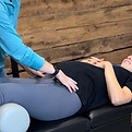 Chiropractor providing prenatal pelvic care to a pregnant patient