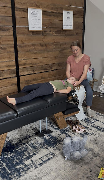 Chiropractor providing a gentle pediatric neck adjustment