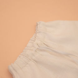 close up of elastic waist band of white linen pants