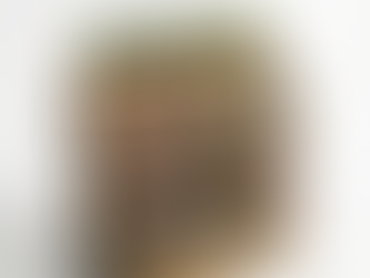 Wooden display stand from the Torres brand with inclined crates containing bottles of white and rosé wine, arranged in rows, with some shelves partially empty and the brand name engraved in the wood.