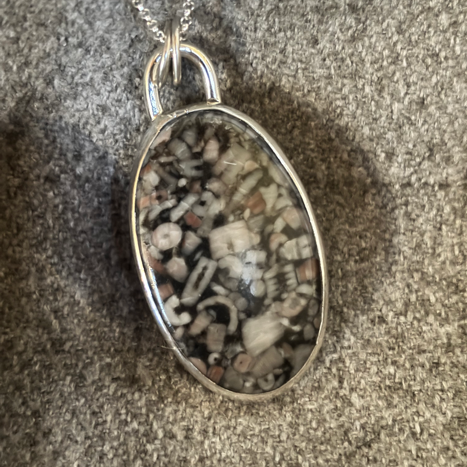 Crinoid marble silver pendant front view