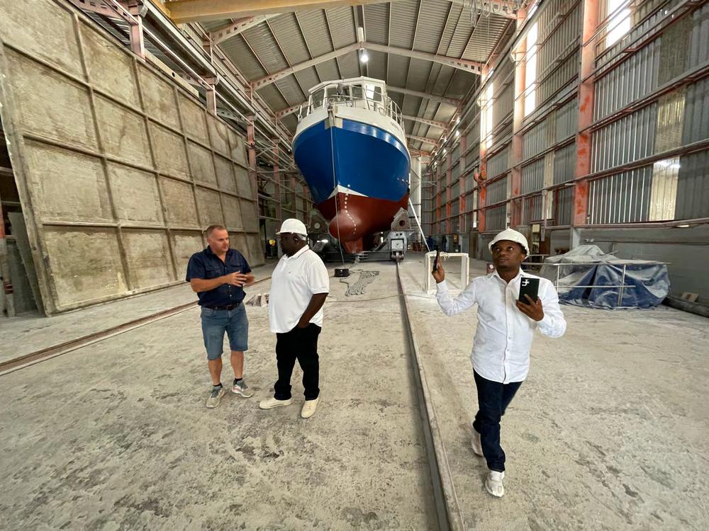 Workboat under construction in a covered shipyard