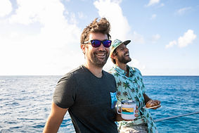Two friends enjoying coffe on morning sunrise coffee cruise on the vida mia