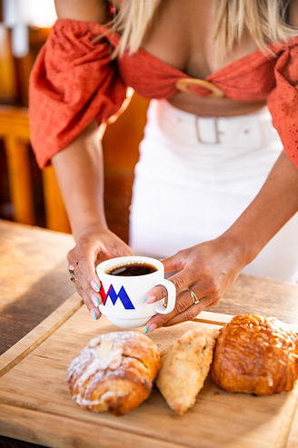 Women picking up coffee and pastries on morning coffee cruise on the vida mia