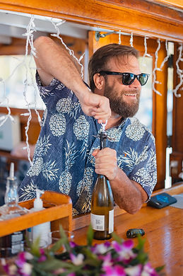Bartender Opening a wine bottle on vida mia