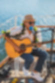 Musician playing guitar on the vida mia, Honolulu HI