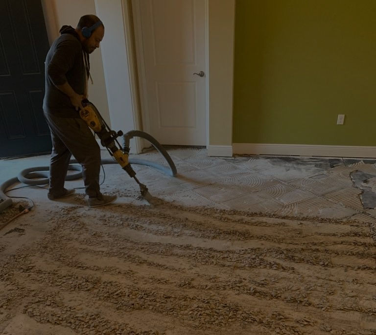 High angle view of tile removal equipment capturing dust in a residential room