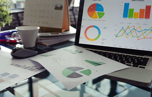 Data on paper and a computer screen displaying the data for seo strategy services