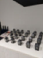 A bunch of small lantern candle-holders as wedding favors spread out on a table