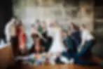 A large wedding party all posing and lounging for a fun photo, industrial chic venue space