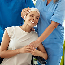A cheerful patient in a wheelchair receives heartfelt support from dedicated healthcare pr