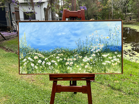 This beautiful oil painting can sit above a lounge, a bed, a console...Merging sea with sky the eye wanders in to a peaceful horizon. The foreground is filled with whimsical windswept flowers. A classic colour palette to compliment any space. Blues, greens, soft butter lemon yellow, white. Windswept beach and grassy hills