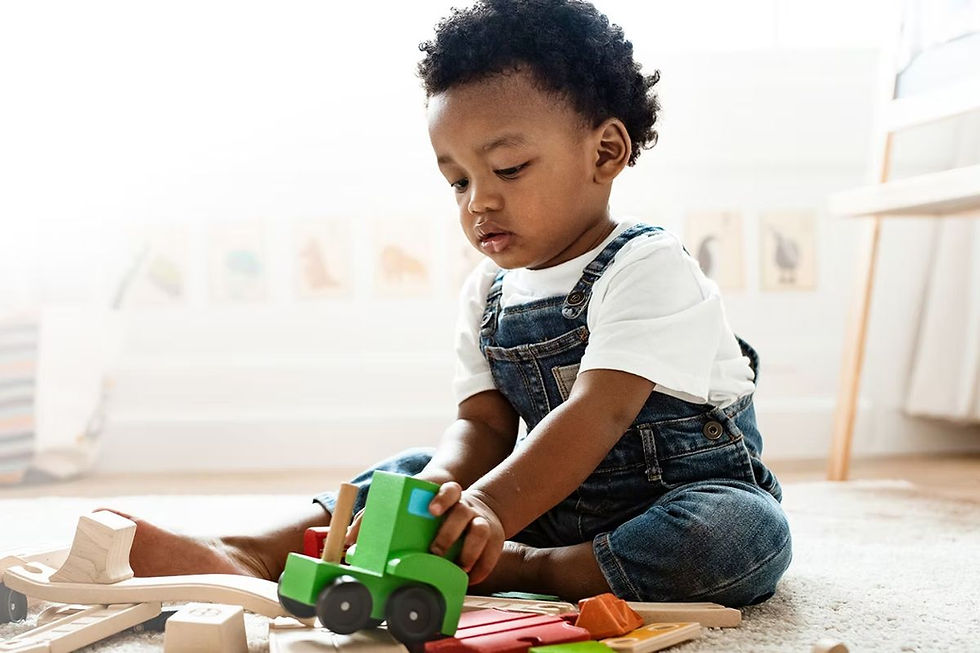 Toddler playing with toy train