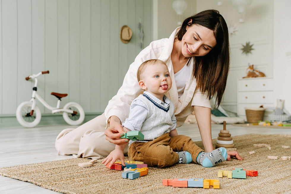 Mother playing with toddler and blocks