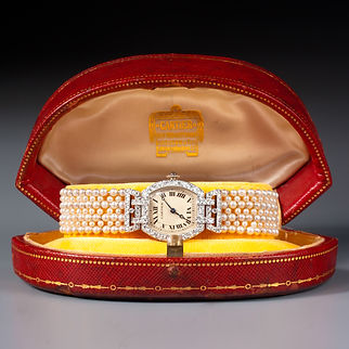 AN EXQUISITE EARLY 20TH CENTURY NATURAL PEARL AND DIAMOND TONNEAU WRISTWATCH BY CARTIER. CIRCA 1919.