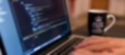 Employee typing code on computer