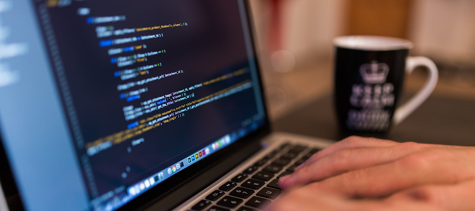 Employee typing code on computer