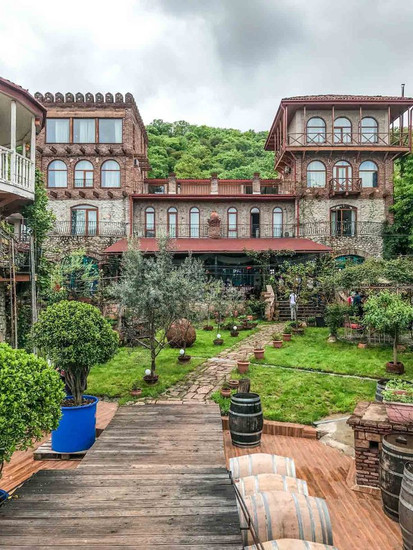 Restored 19th-century Georgian noble estate with courtyard gardens and wooden balconies – exclusive-use corporate retreat venue in Georgia wine country