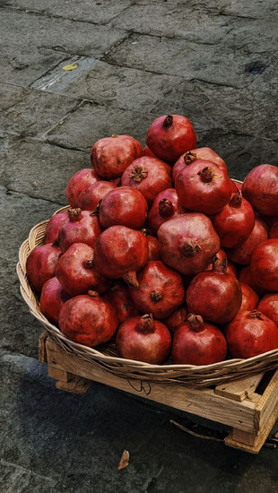 Fresh pomegranates in a basket at a Georgian market – Georgia's UNESCO-recognized cuisine and vibrant food culture create unique culinary programming for corporate retreats