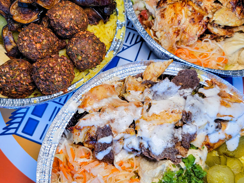 Chicken shawarma and falafel bowls with fresh salads