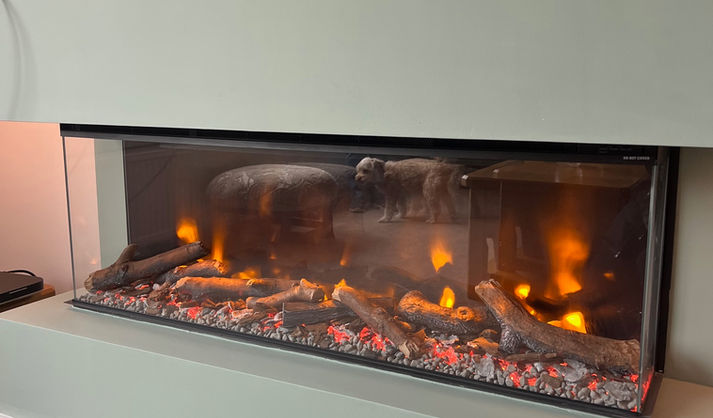 long glass fronted fireplace at bottom of a media wall