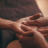 two hands massaging one hand