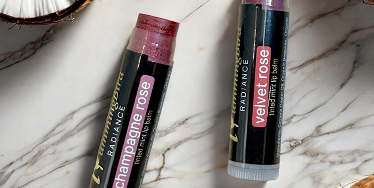 Close-up view of a variety of lip balm tubes on a wooden surface