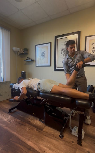 Dr. Kevin Rosario performing an assessment on the lower extremity.
