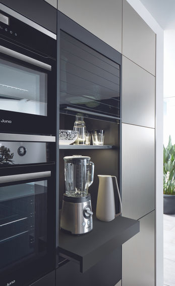 tambour unit by schuller kitchens Open sliding glass unit for small appliances in Schuller German kitchen with onyx black finish.