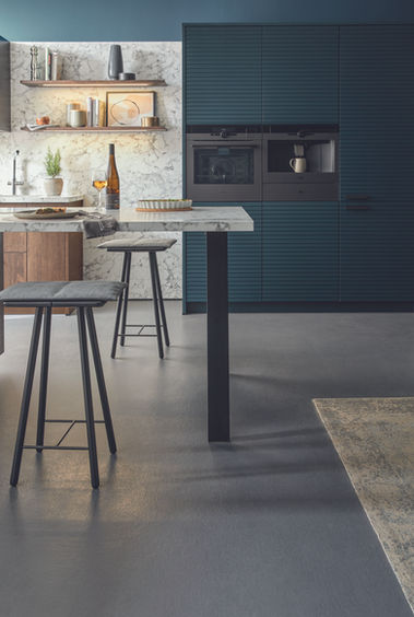Blue kitchen with matt black ovens 